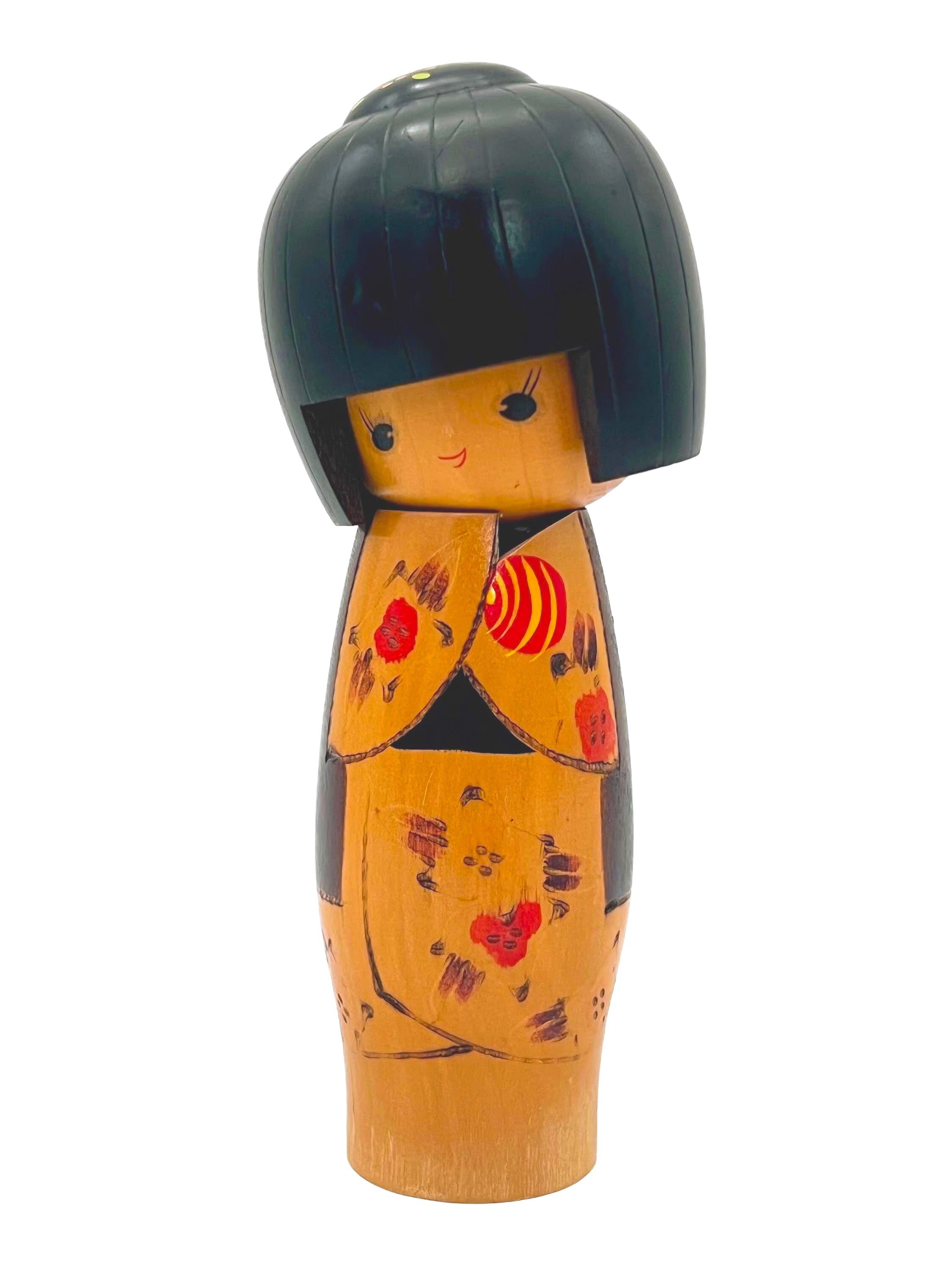 Traditional vintage Japanese Kokeshi doll made of hand-painted wood with floral accents.