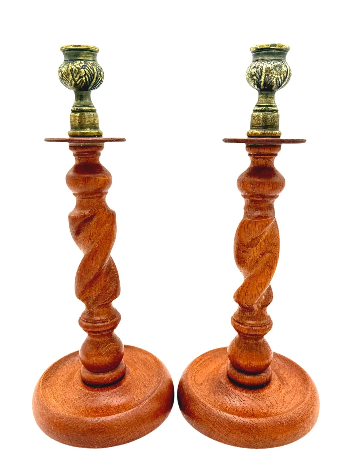 Antique English wooden barley twist candlesticks topped with aged brass thistle-shaped cups.