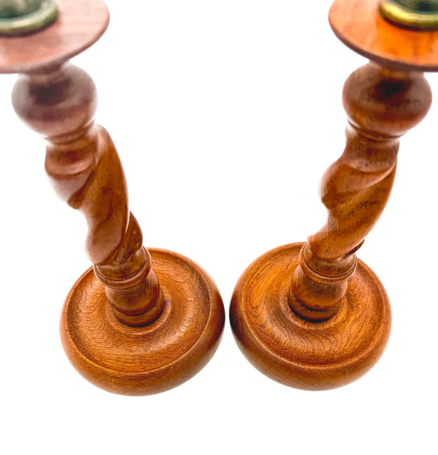 Antique English wooden barley twist candlesticks topped with aged brass thistle-shaped cups.