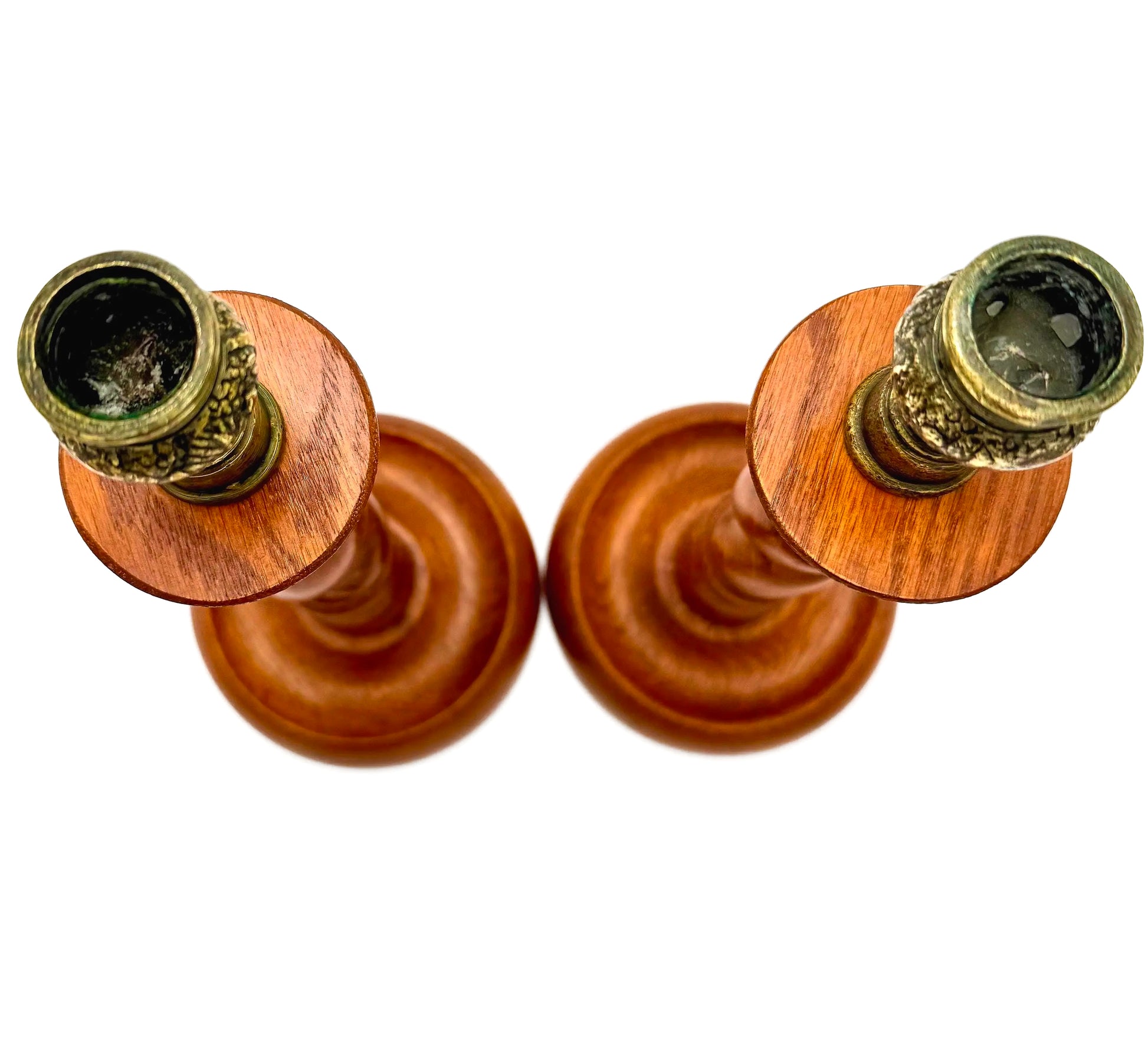 Antique English wooden barley twist candlesticks topped with aged brass thistle-shaped cups.