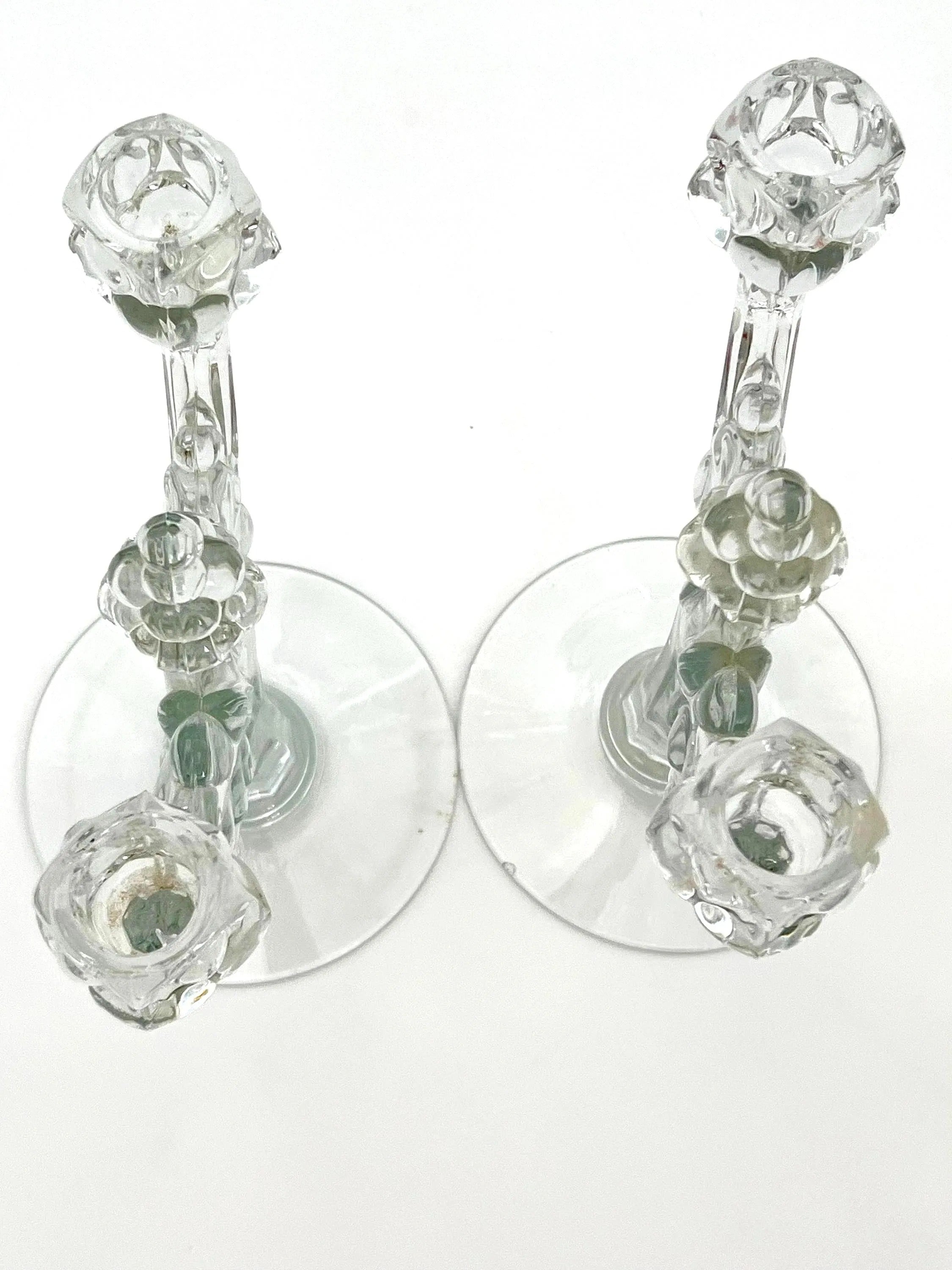 Pair of 1930s Heisey glass candelabras featuring rare molded grape cluster designs and elegant glass arms.