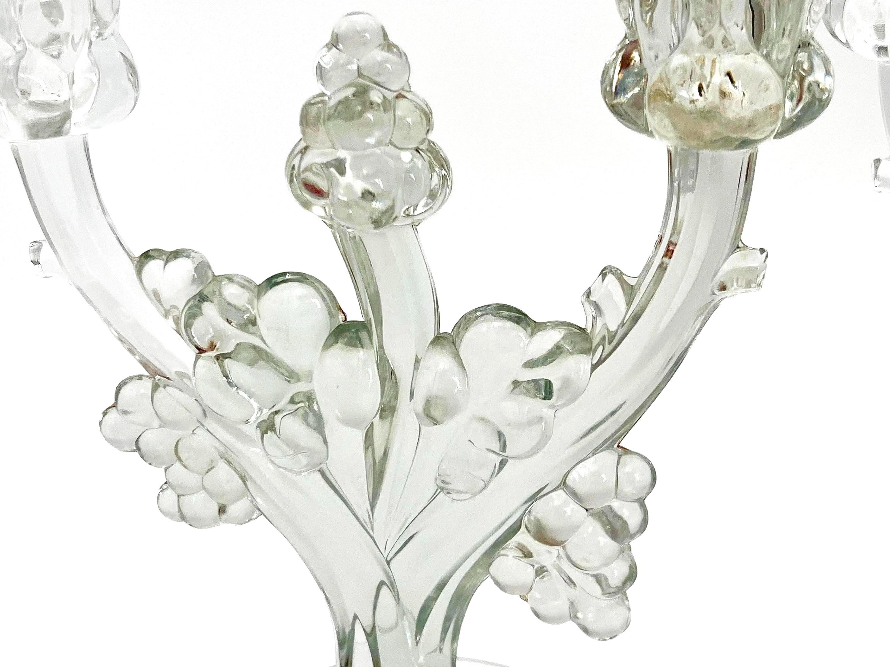 Pair of 1930s Heisey glass candelabras featuring rare molded grape cluster designs and elegant glass arms.