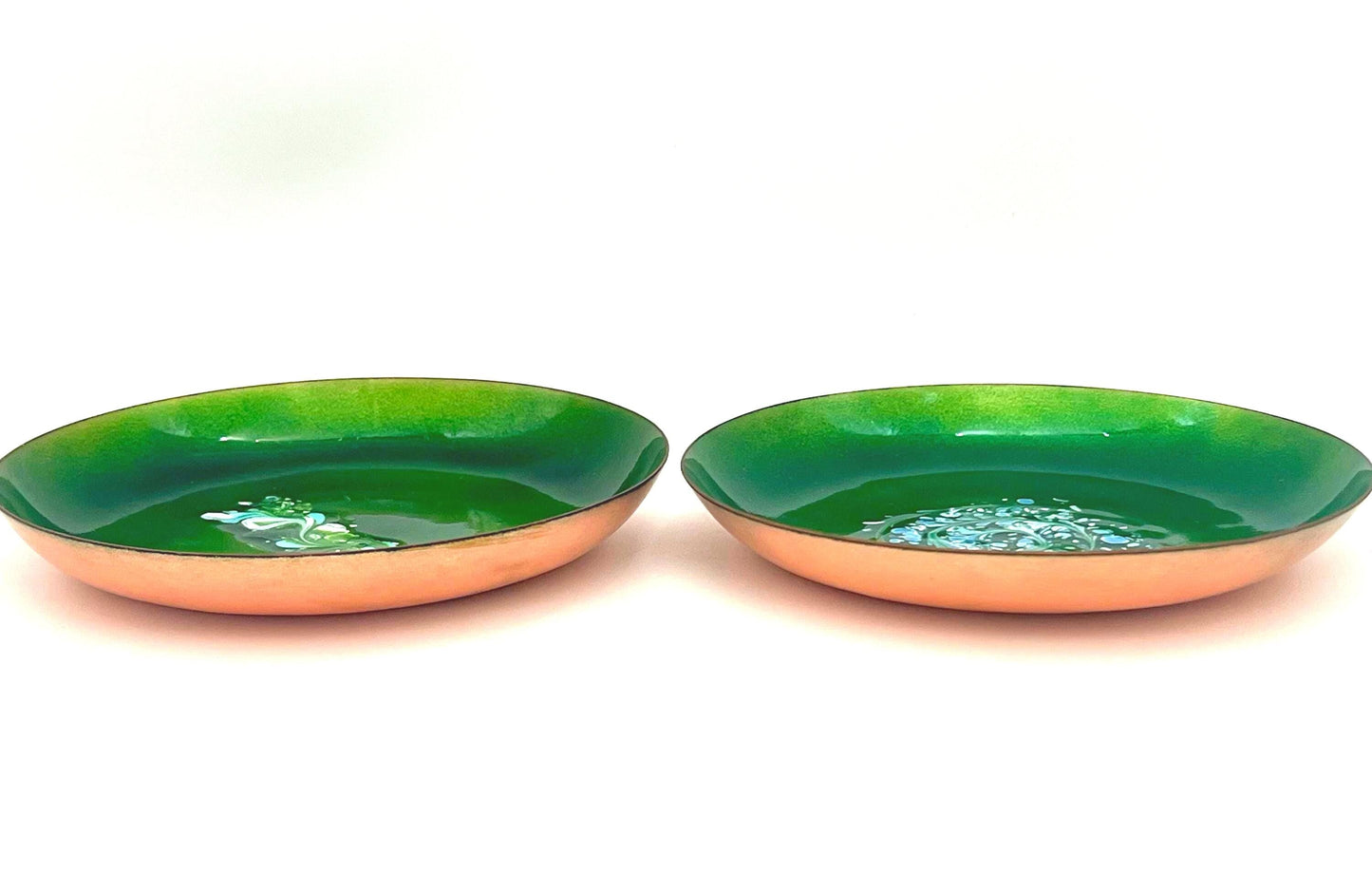 Pair of vintage copper wall art plates with mid-century designs, signed by Statham.