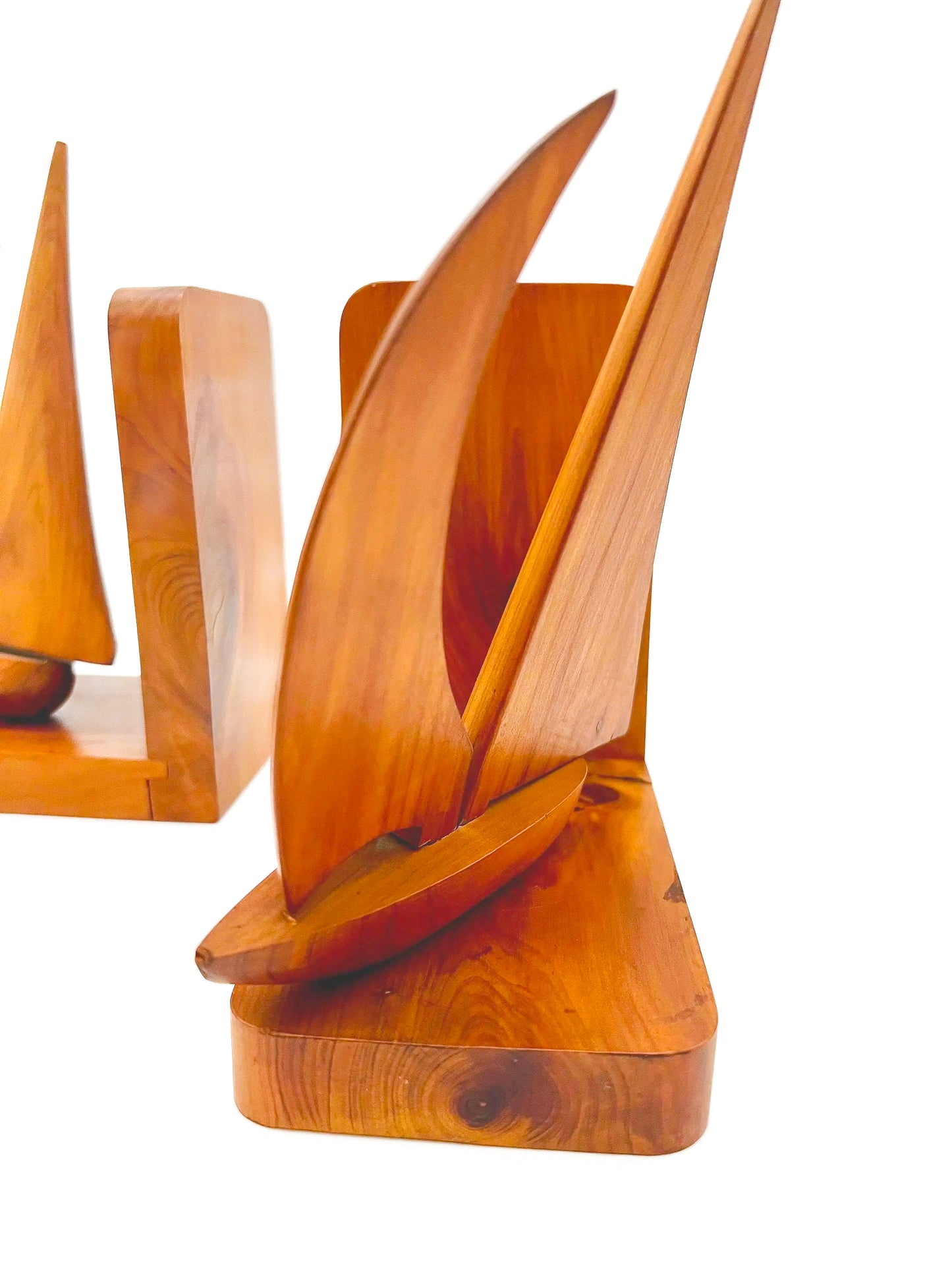 Pair of 1965 mid-century modern teak wood bookends carved in the shape of sailboats.