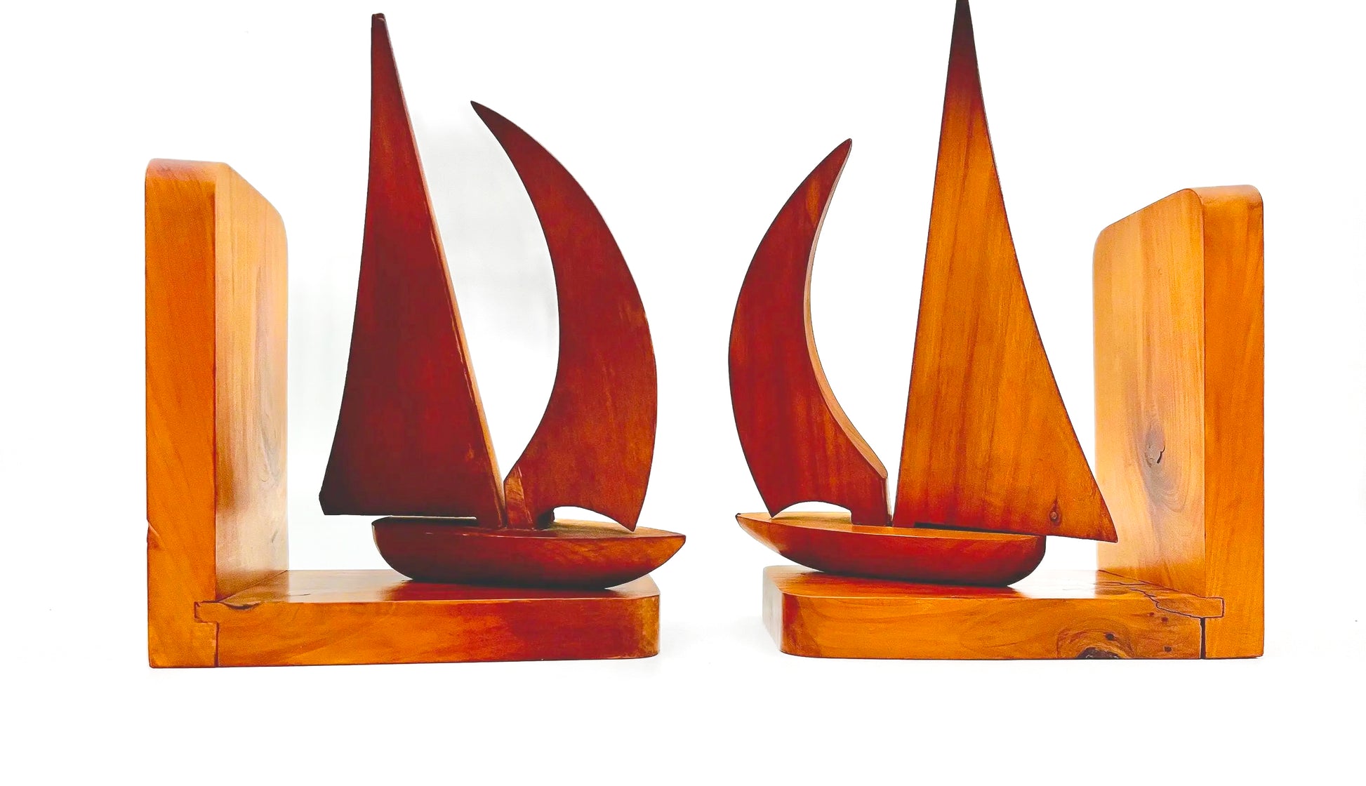 Pair of 1965 mid-century modern teak wood bookends carved in the shape of sailboats.