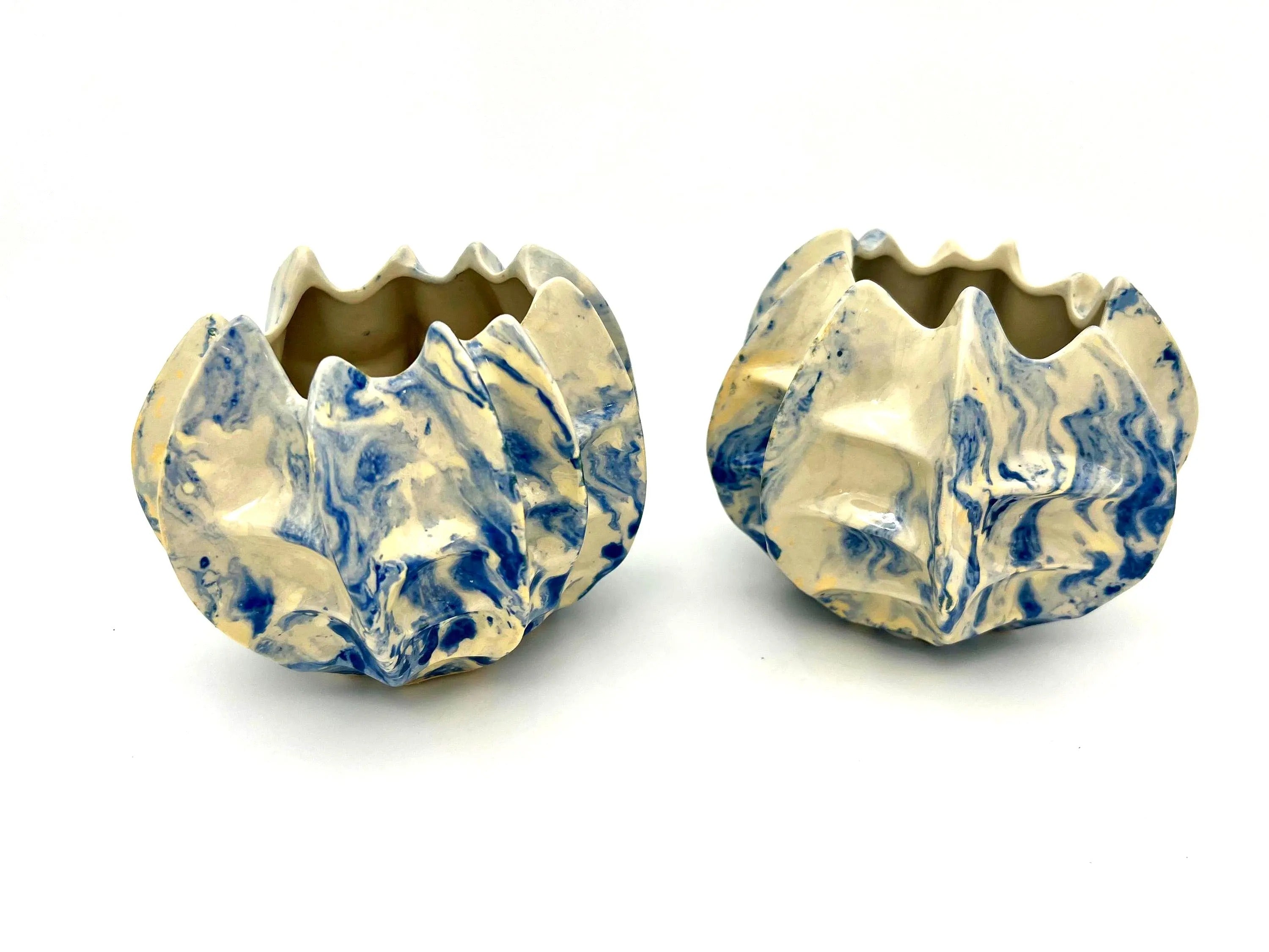 Pair of vintage ceramic planters or candle holders with an abstract blue and white splatter-ware pattern.