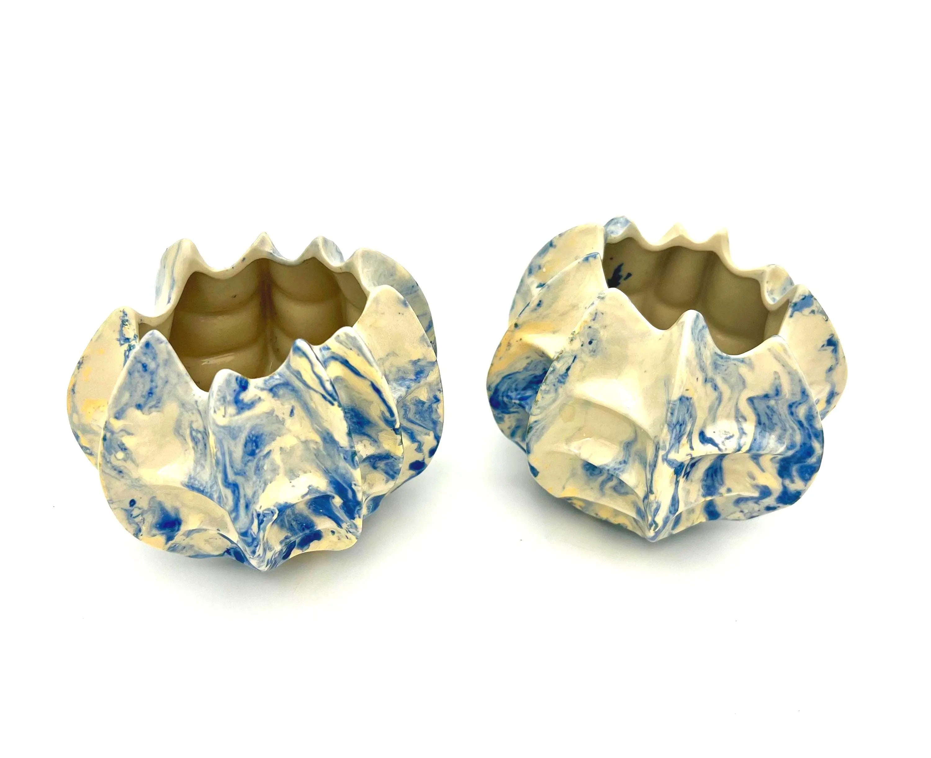 Pair of vintage ceramic planters or candle holders with an abstract blue and white splatter-ware pattern.