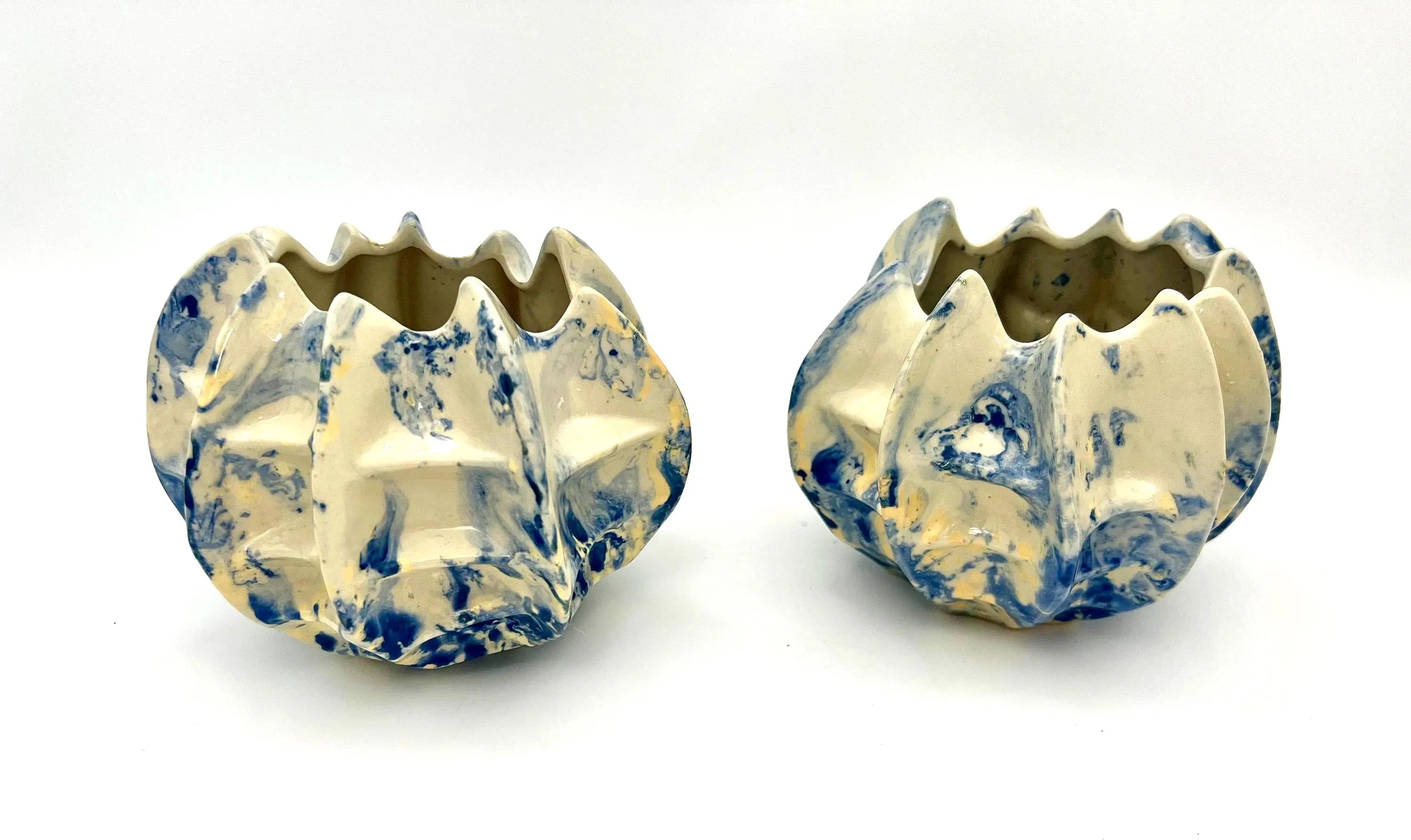 Pair of vintage ceramic planters or candle holders with an abstract blue and white splatter-ware pattern.