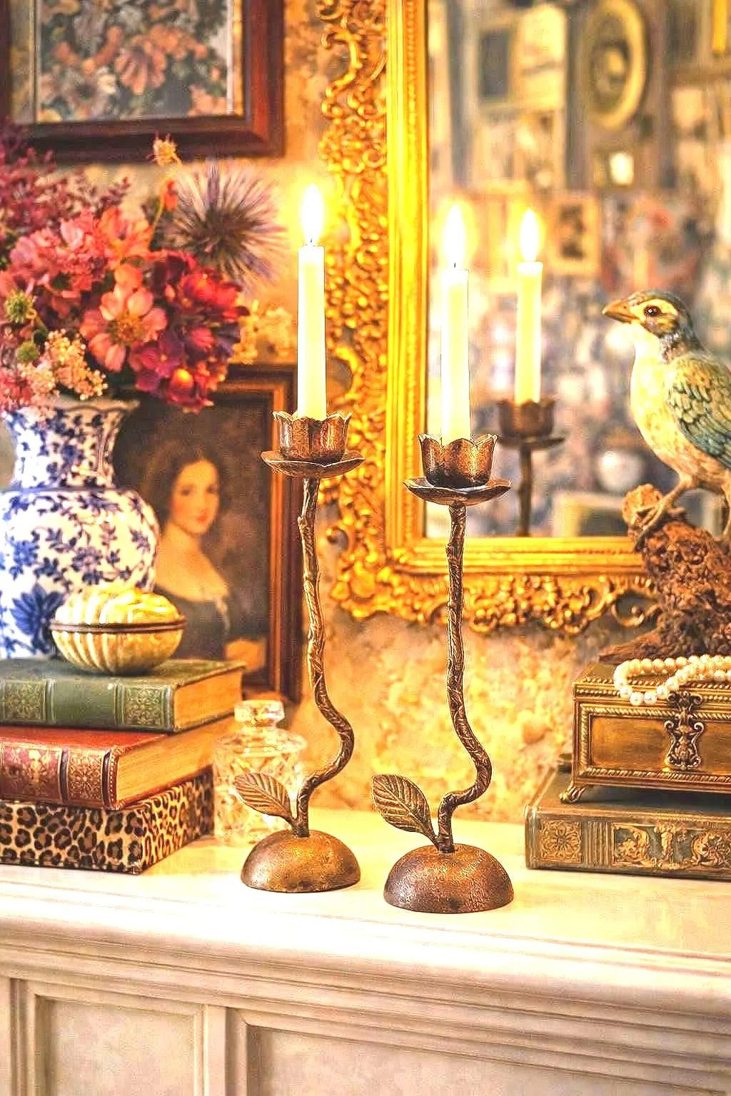 Pair of artistic hand-forged bronze taper candle holders shaped like long-stemmed roses.