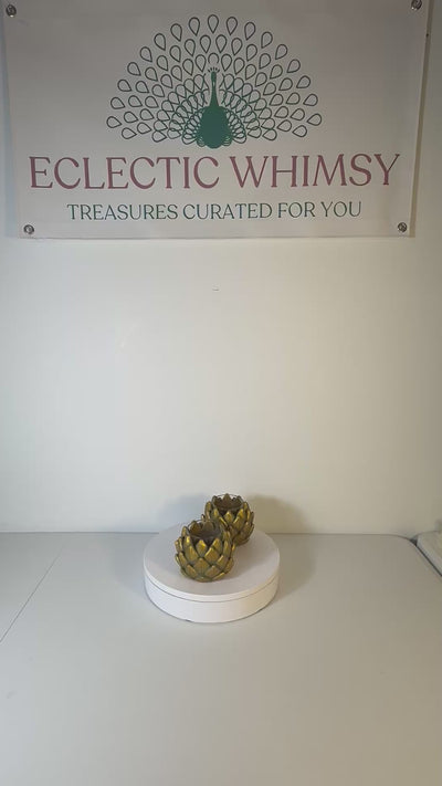 Pair of heavy vintage votive holders shaped like golden artichokes with a metallic finish.
