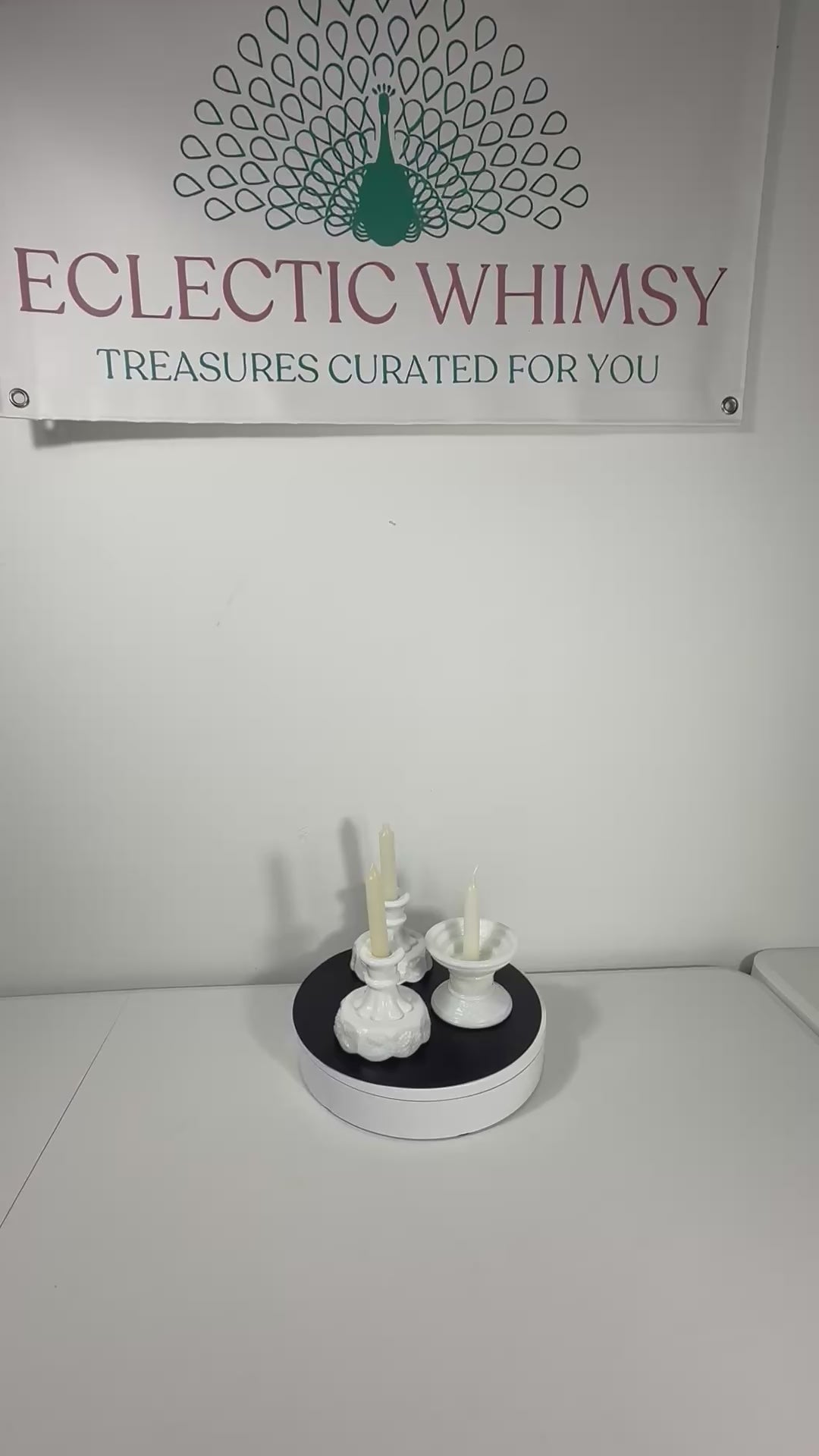 A curated trio of vintage milk glass candle holders in varying heights and classic patterns.