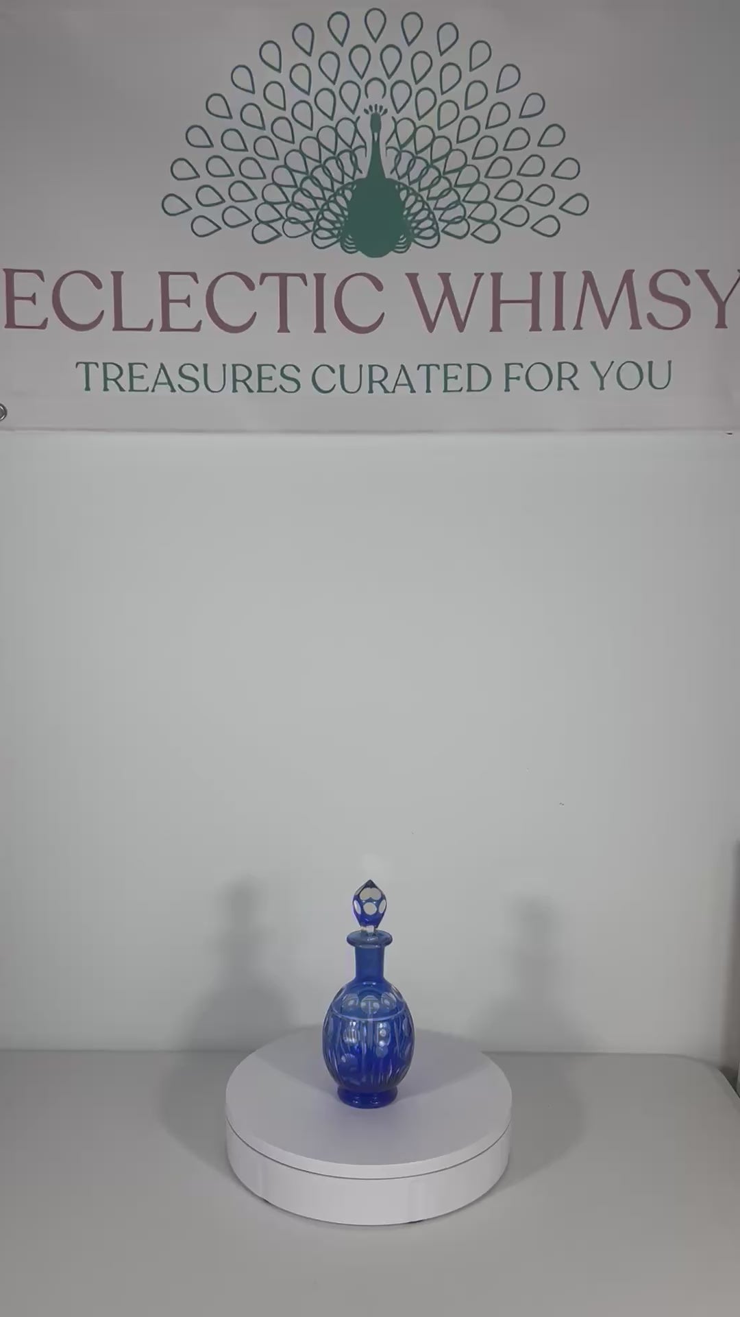 Minimalist mid-century modern decanter in a deep cobalt blue glass with a matching round stopper.