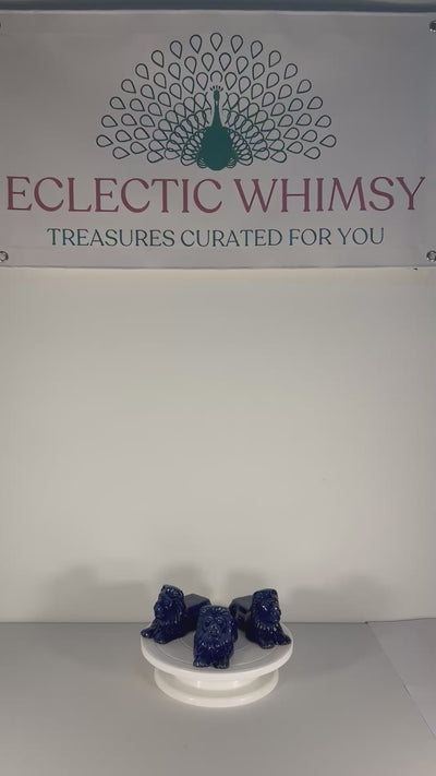 Set of three decorative terra cotta lion sculptures in a unique petroleum blue glaze.