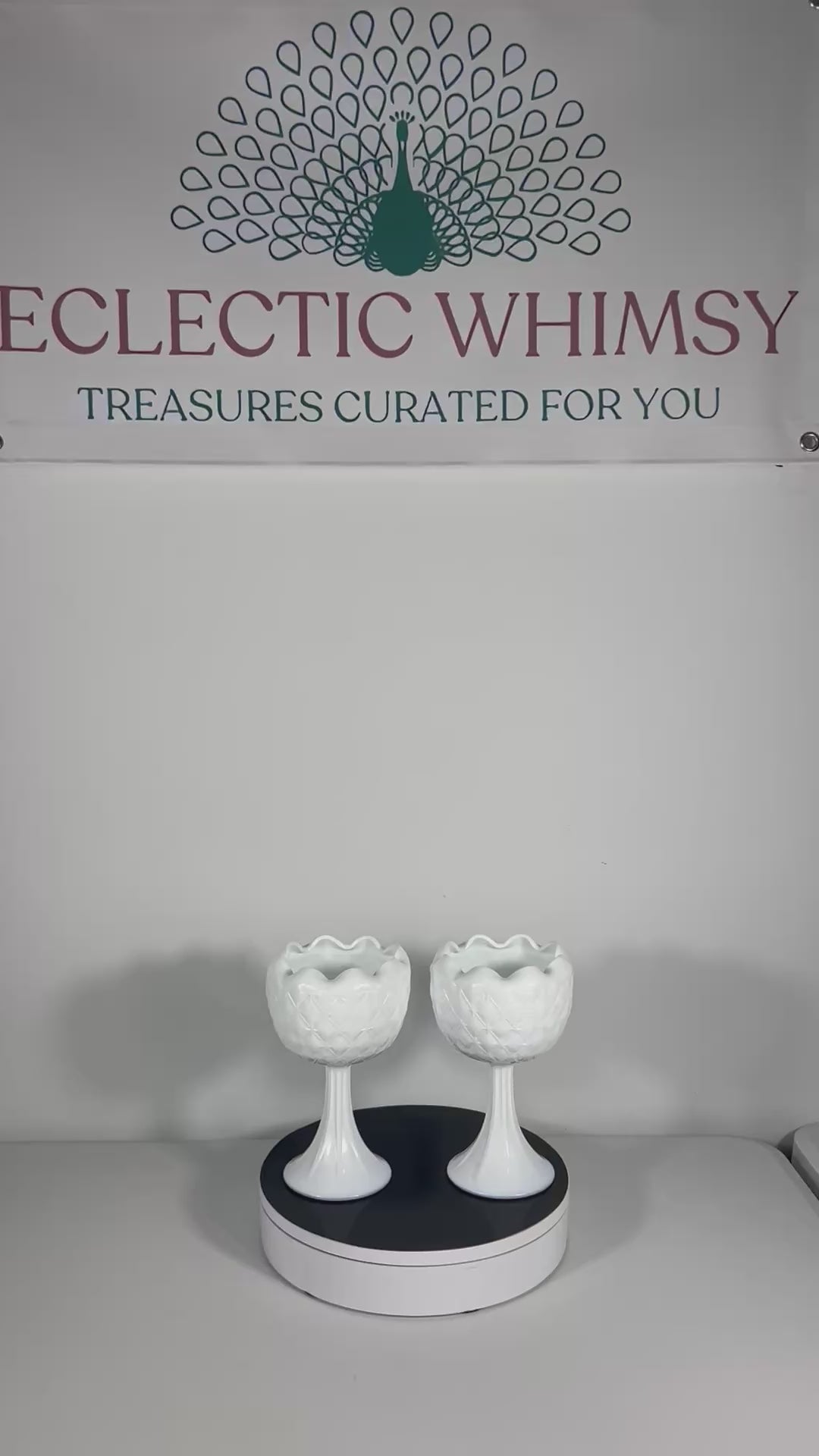 A curated duo of vintage milk glass candle holders in varying heights and classic patterns.