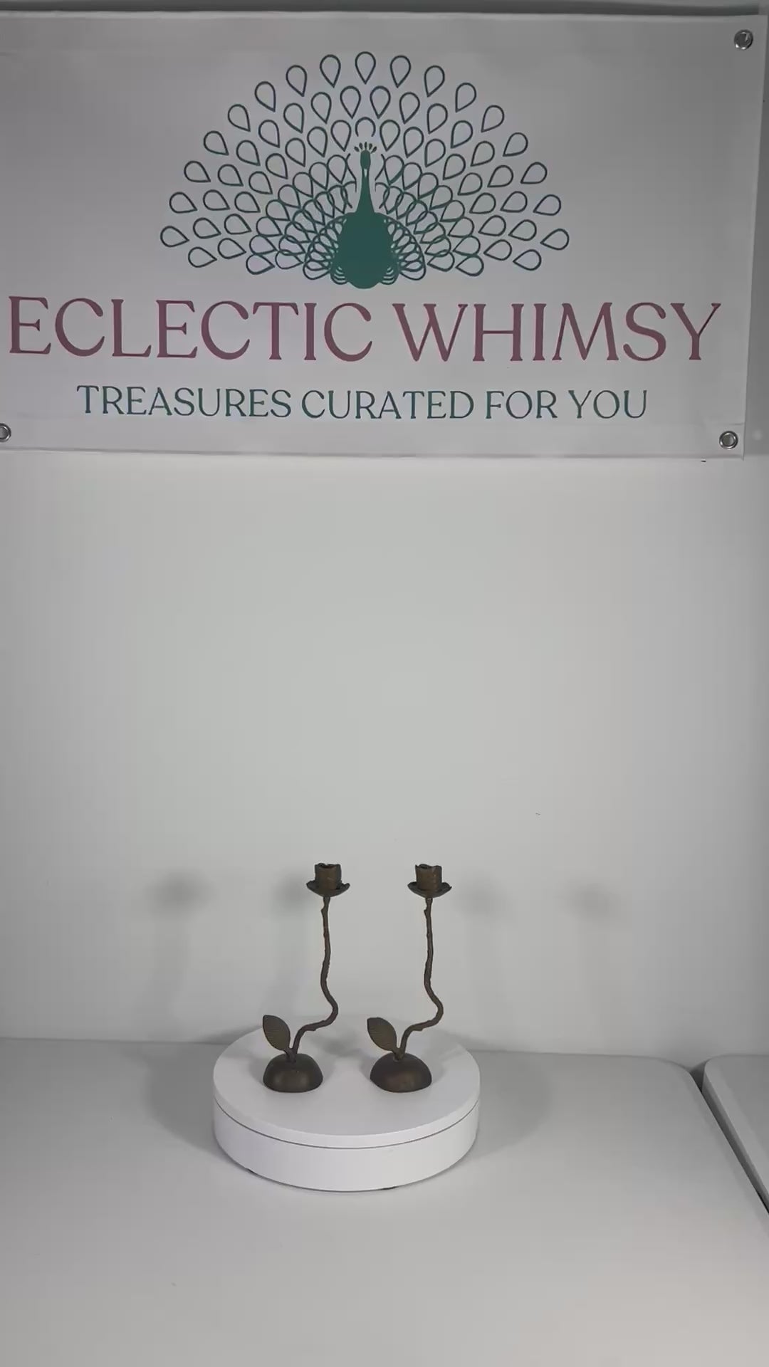 Pair of artistic hand-forged bronze taper candle holders shaped like long-stemmed roses.