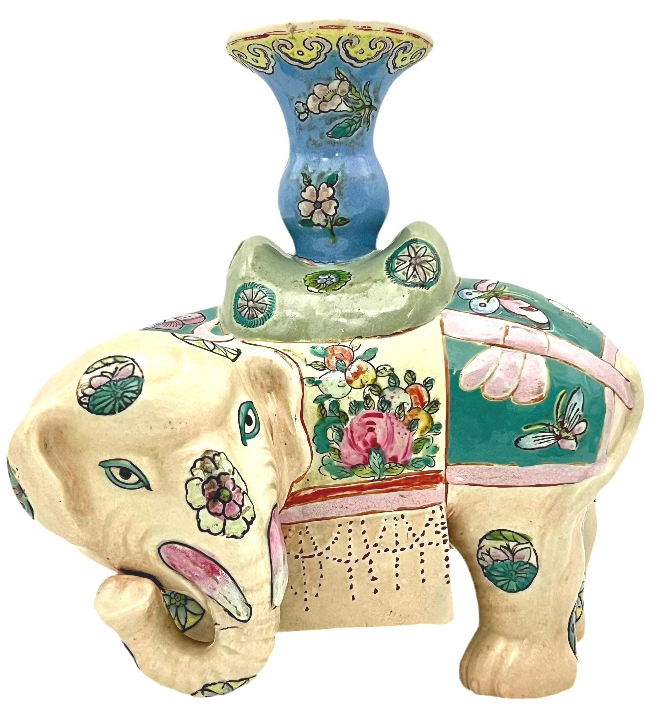 Hand-painted antique Chinese porcelain elephant candleholder with an ornate saddle and floral motifs.
