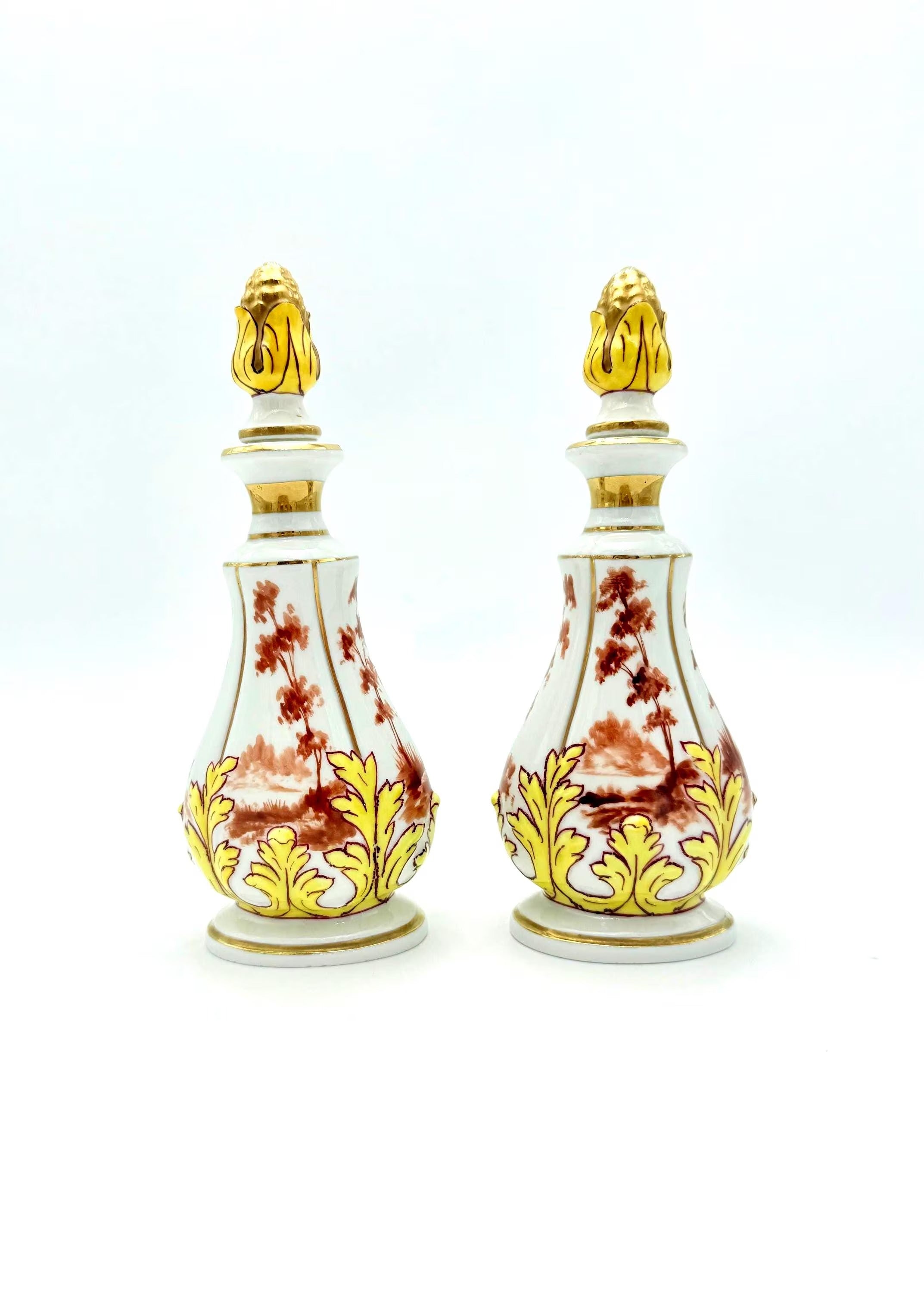 Pair of 19th-century French porcelain cologne bottles with intricate hand-painted Victorian scenes.