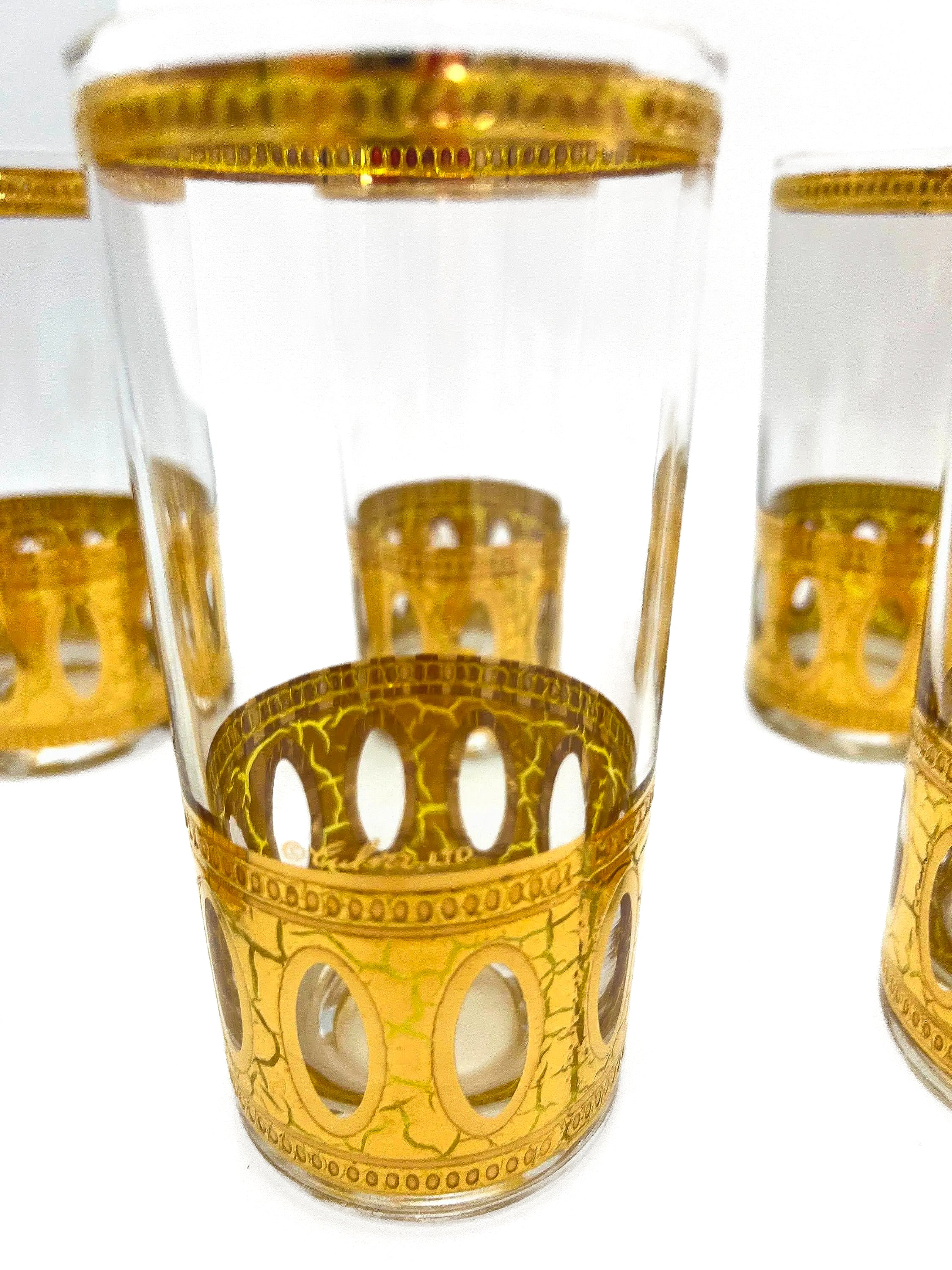 Set of 8 signed vintage Culver highball glasses featuring an intricate 22k gold geometric pattern.