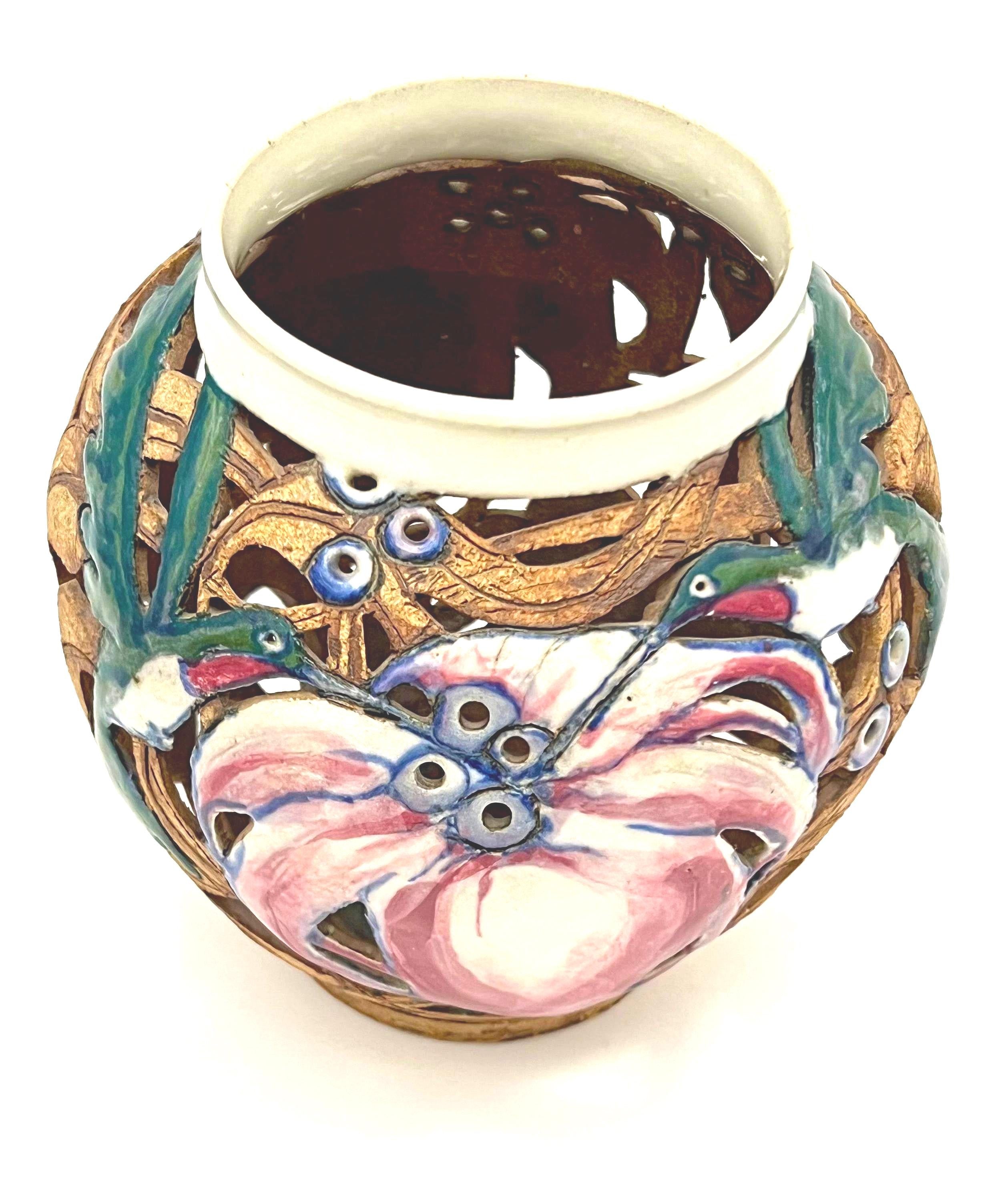Artist-signed decorative piece featuring a hummingbird motif, usable as a vase or candle lantern.