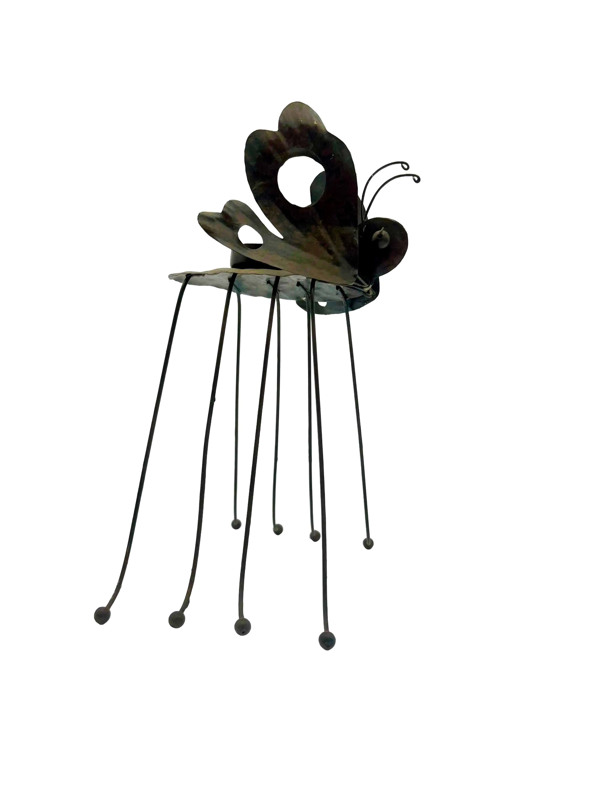 Whimsical vintage metal candle holder shaped like a butterfly with open-work wings.
