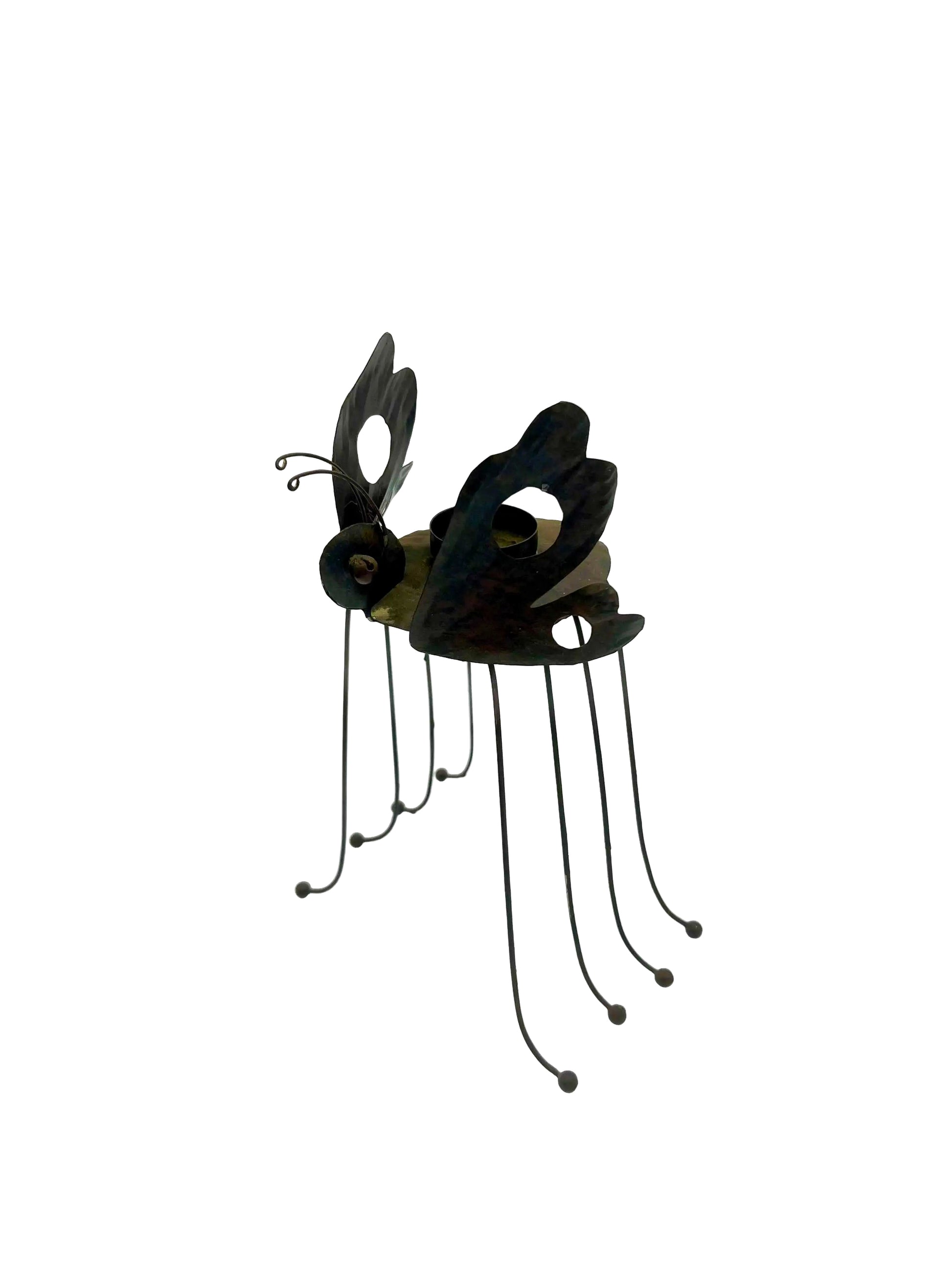 Whimsical vintage metal candle holder shaped like a butterfly with open-work wings.