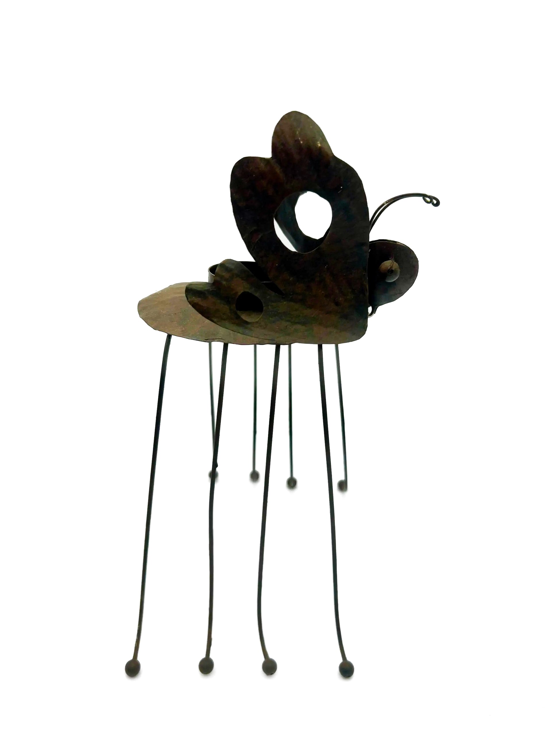 Whimsical vintage metal candle holder shaped like a butterfly with open-work wings.