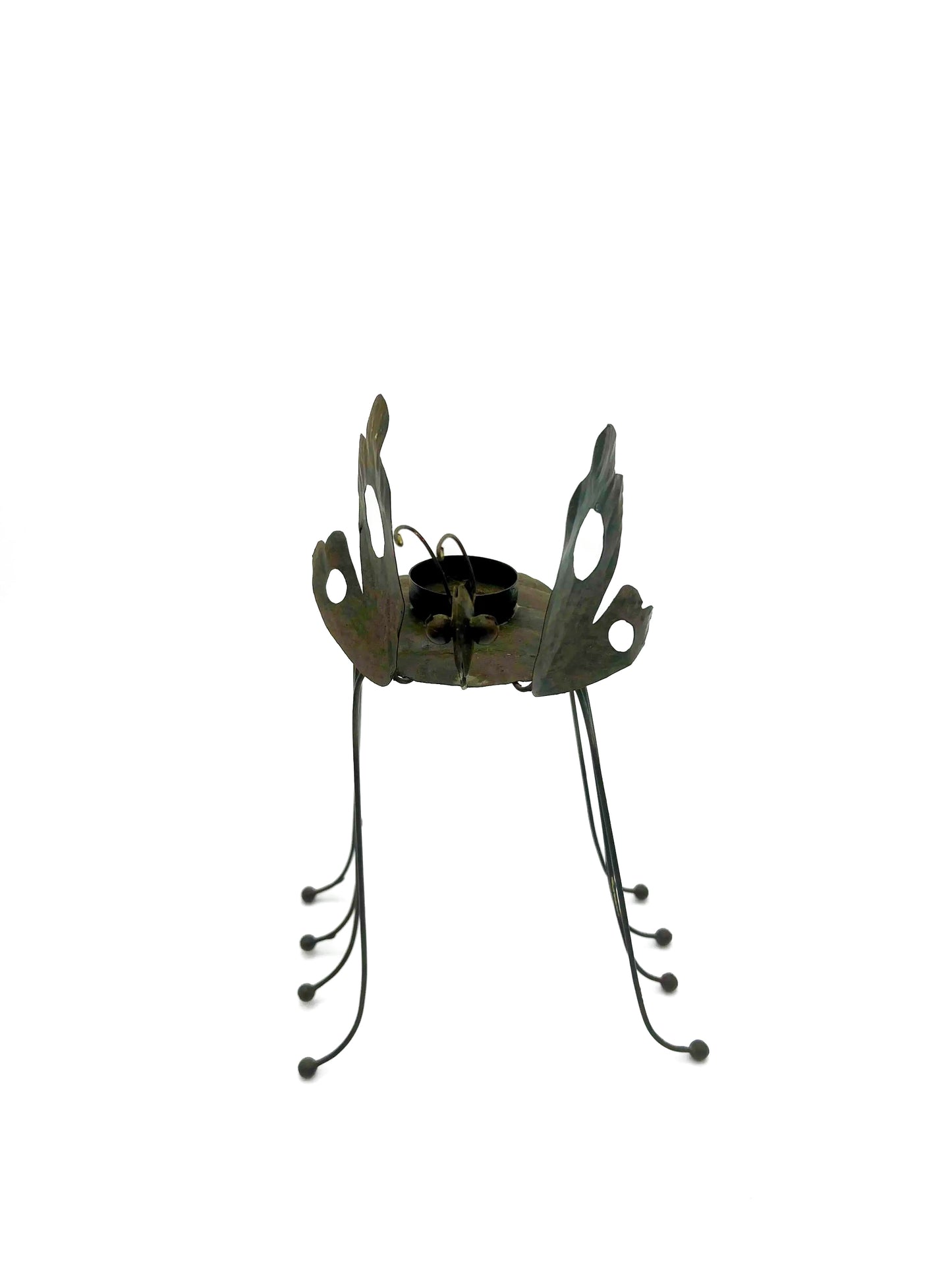 Whimsical vintage metal candle holder shaped like a butterfly with open-work wings.
