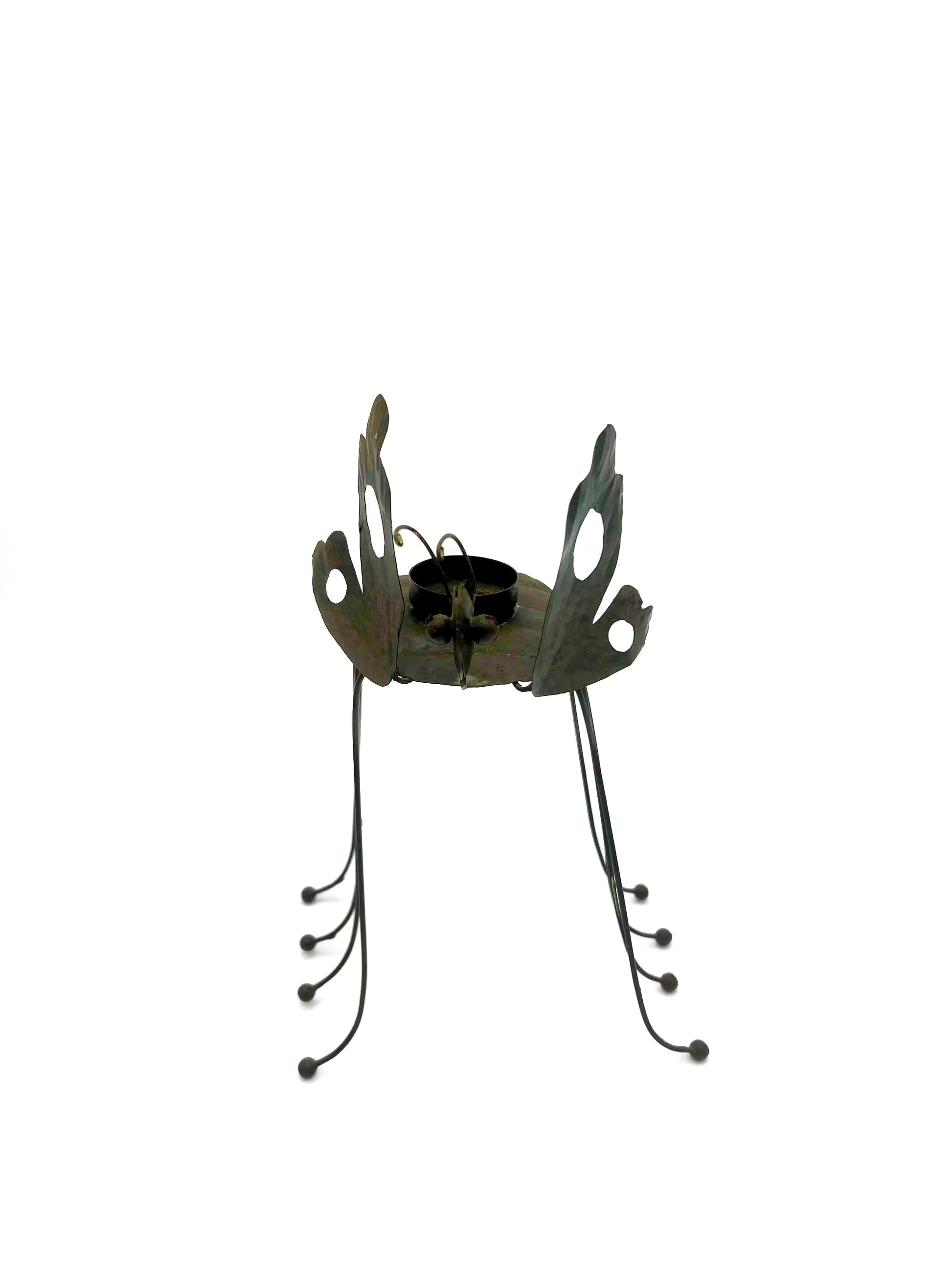 Whimsical vintage metal candle holder shaped like a butterfly with open-work wings.