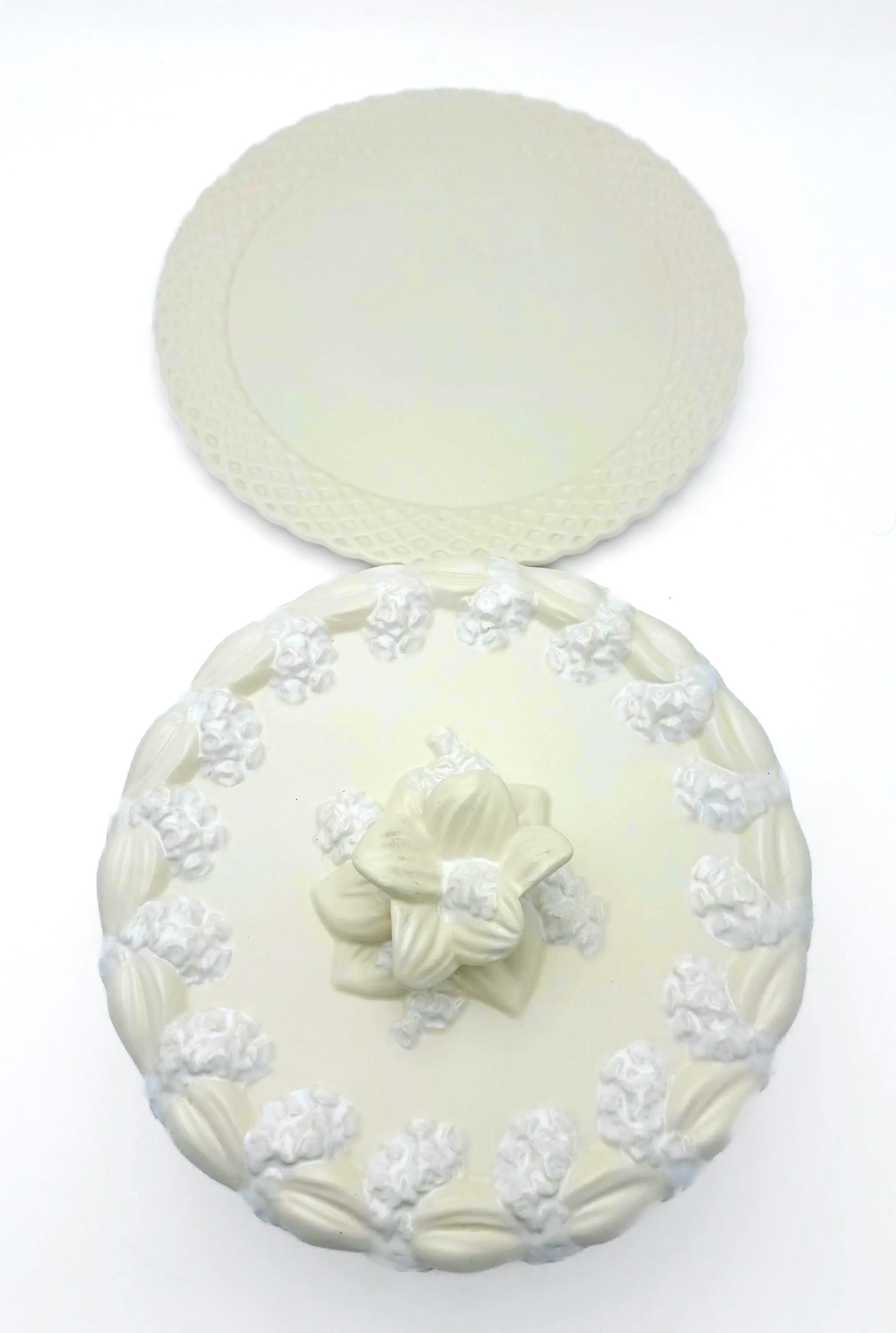 Large Portuguese earthenware dome and matching plate with a cream-white floral relief design.