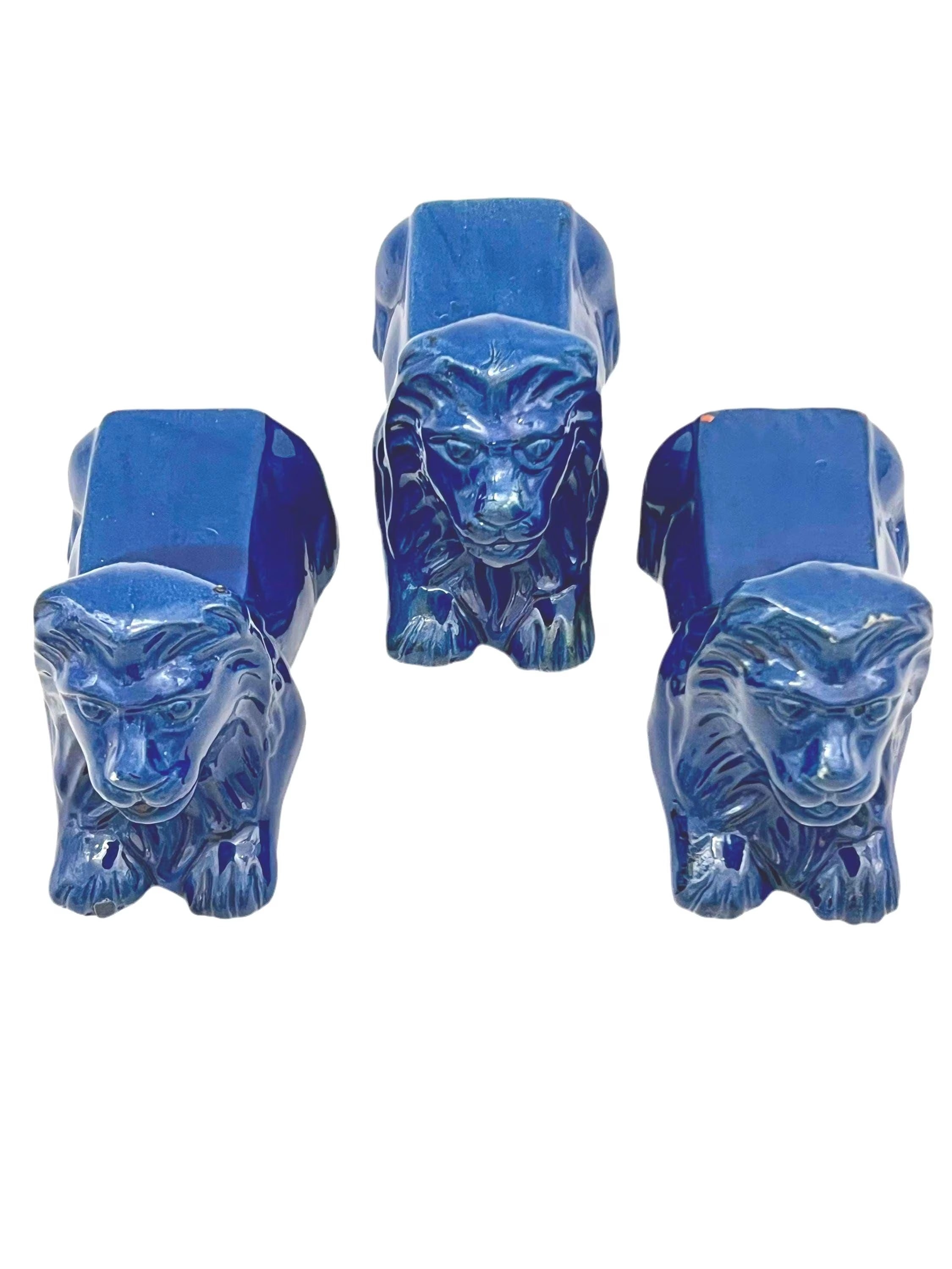Set of three decorative terra cotta lion sculptures in a unique petroleum blue glaze.
