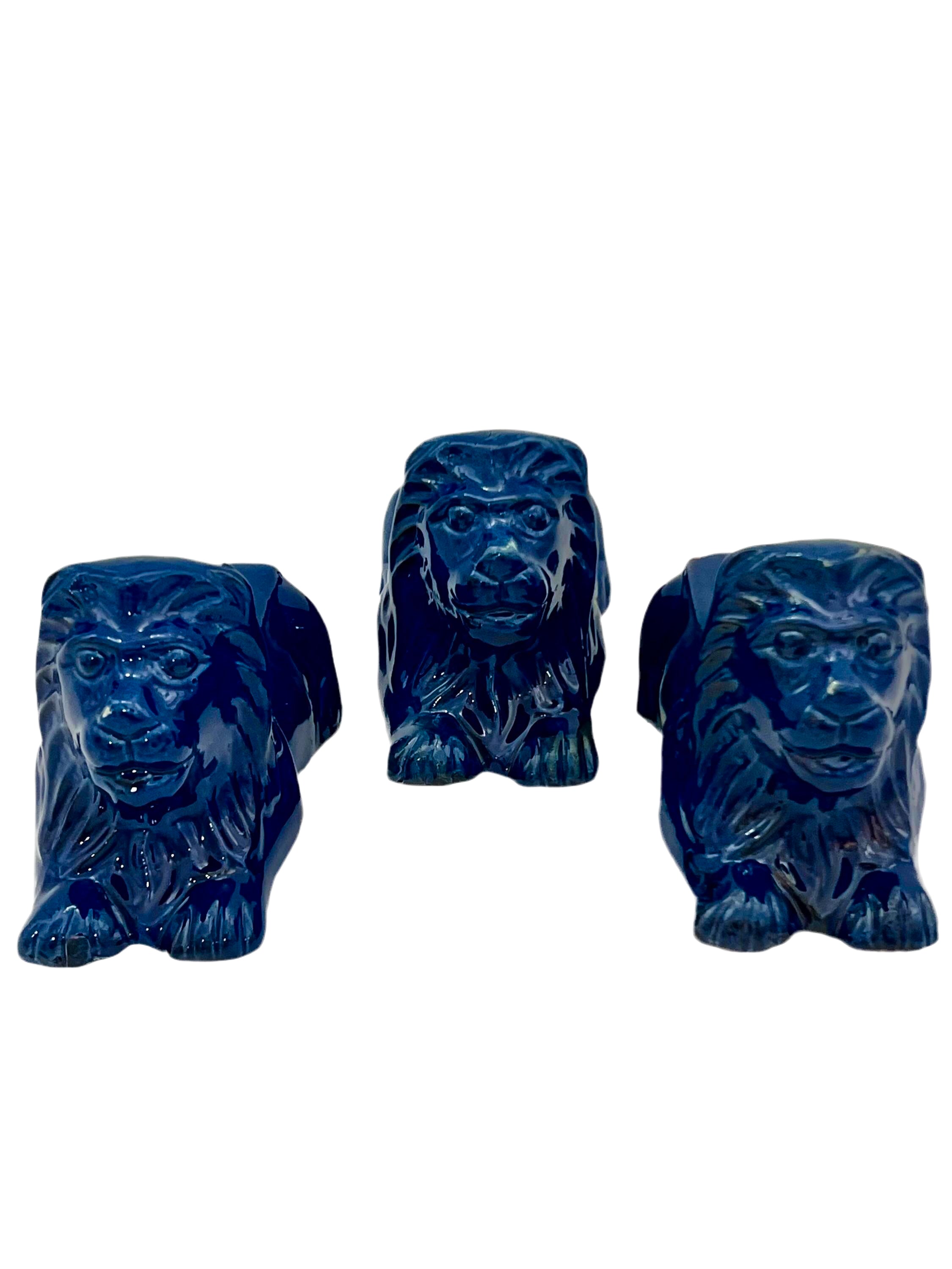 Set of three decorative terra cotta lion sculptures in a unique petroleum blue glaze.