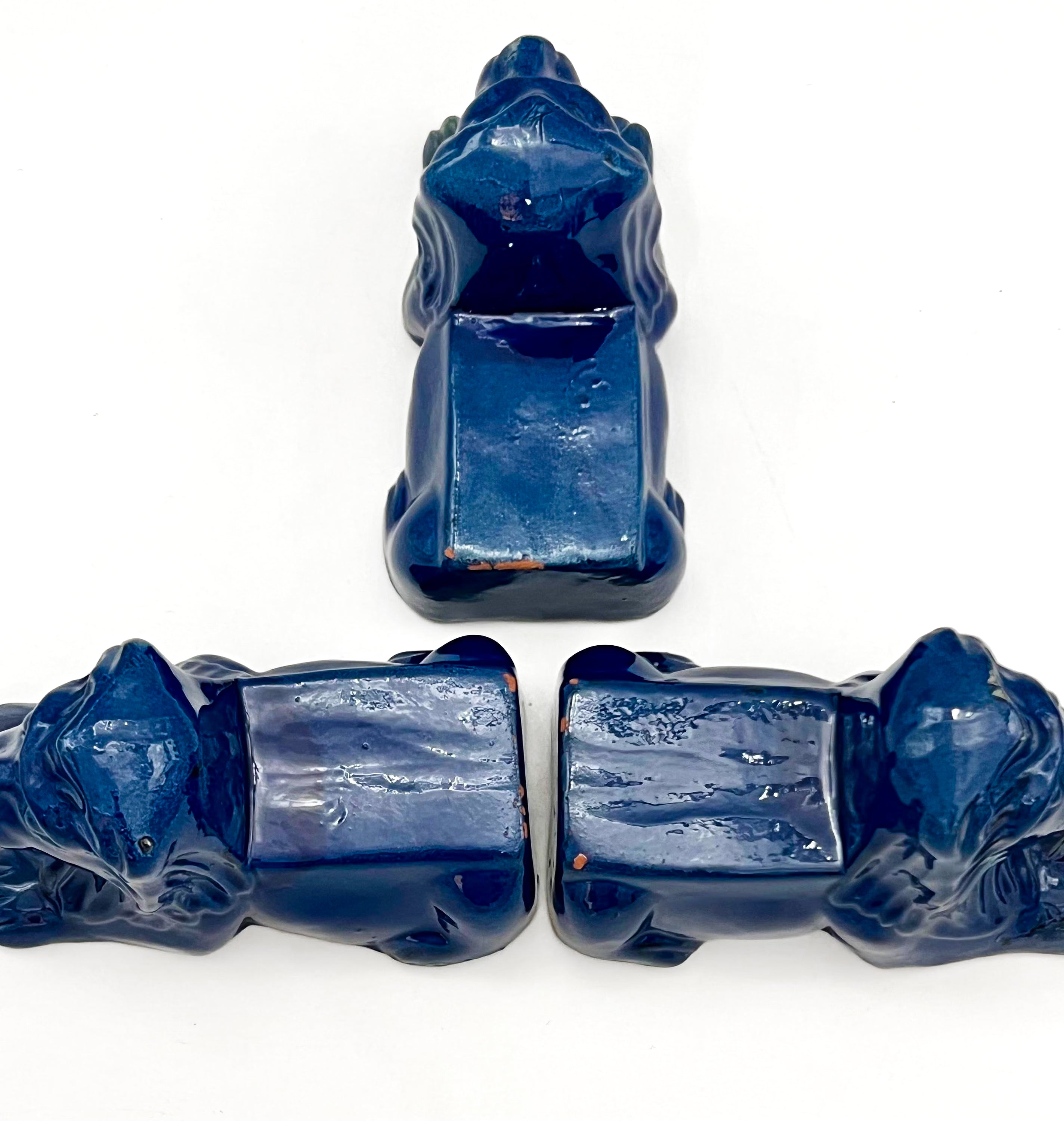 Set of three decorative terra cotta lion sculptures in a unique petroleum blue glaze.