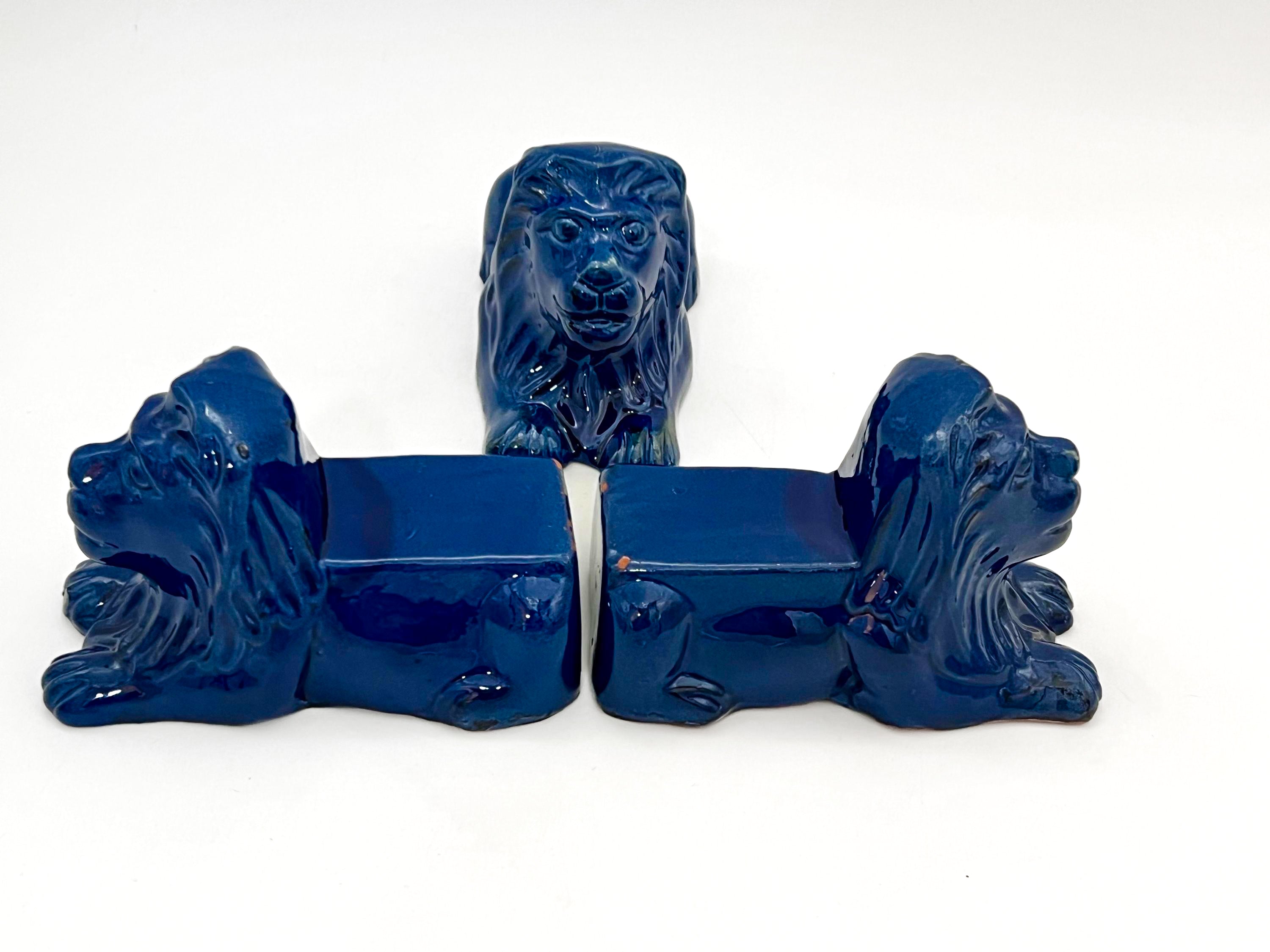 Set of three decorative terra cotta lion sculptures in a unique petroleum blue glaze.